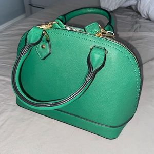 Small green bowler handbag with cross body strap